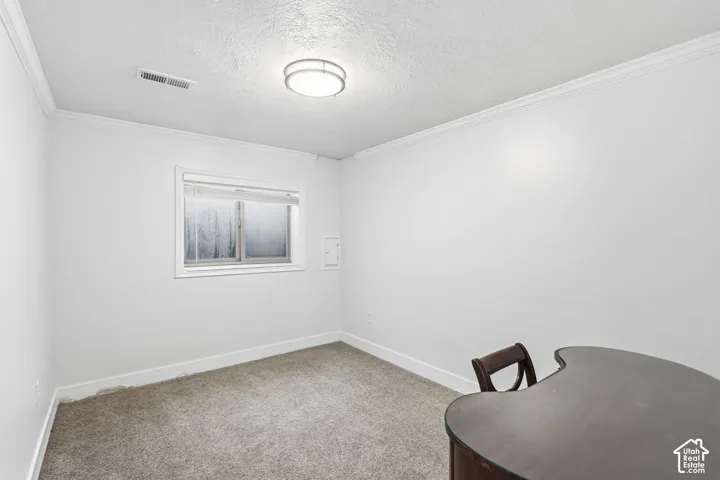 Neutral-toned wall-to-wall carpeting with crown molding,