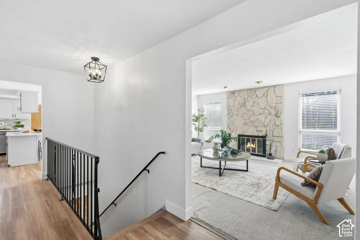 Wrought iron stair railing, wood-finish flooring, and geometric pendant lighting