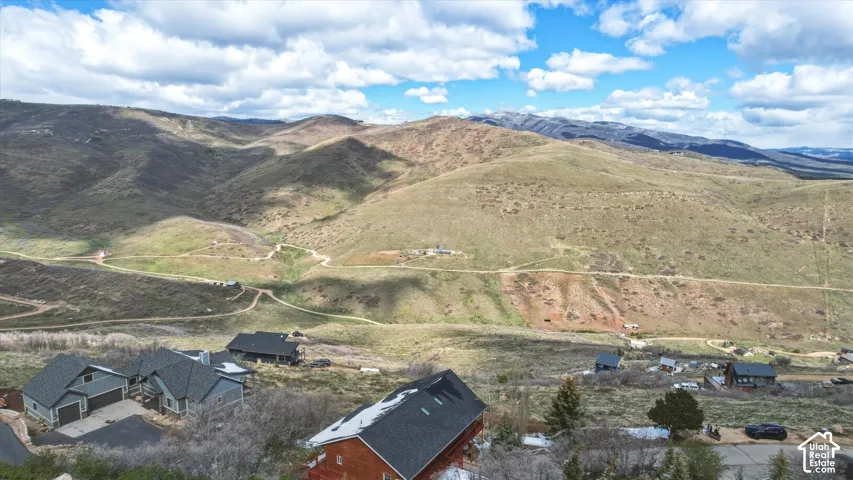 Aerial perspective featuring mountainous terrain with rolling hills and expansive landscape topography
