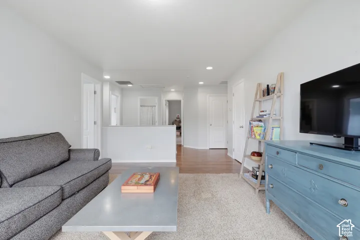 Neutral interior featuring recessed lighting, wood-finish flooring, carpeting, and multiple interior doors