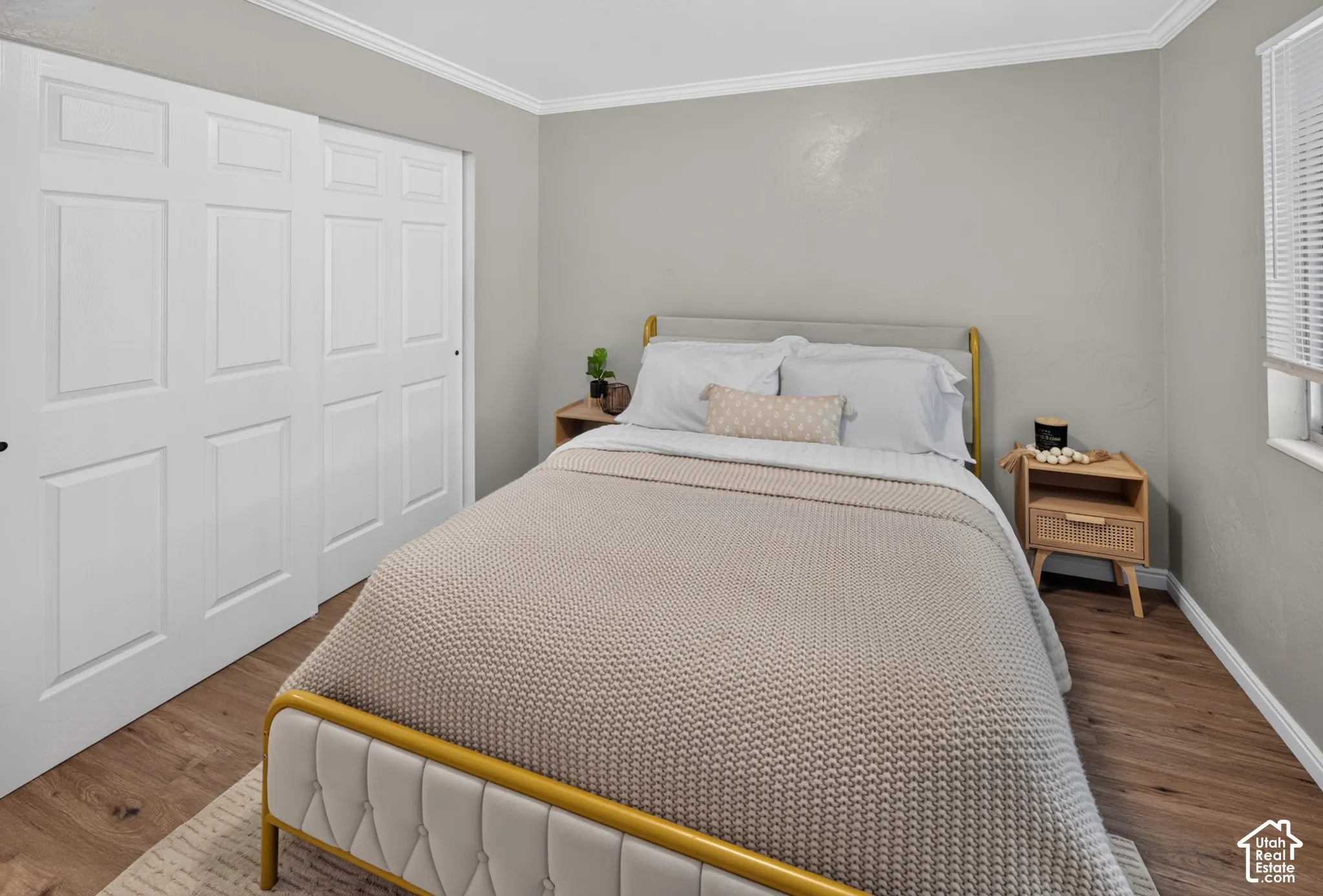 Wood-finish flooring, neutral wall paint, and sliding panel closet doors
