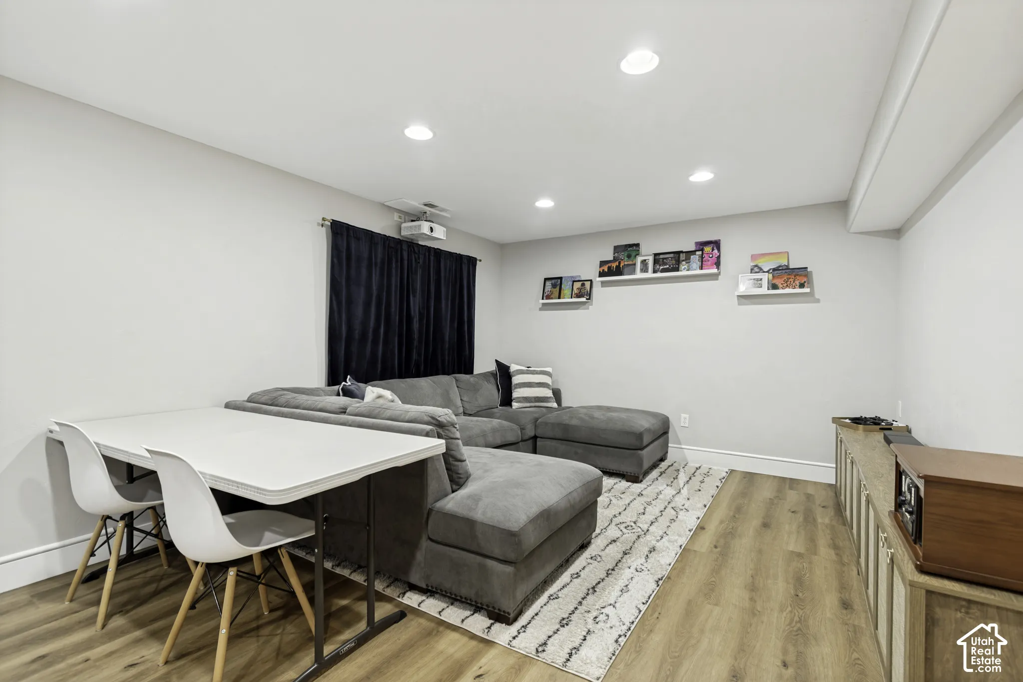 Recessed lighting, wood-finish flooring, and wall-mounted shelving