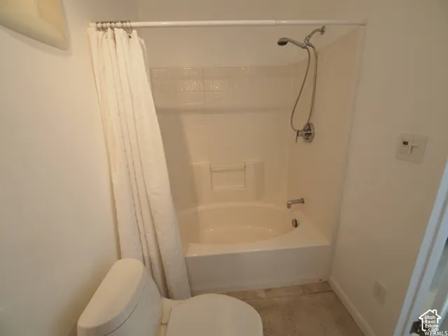 Full-size soaking tub with integrated tile-surround and handheld shower head