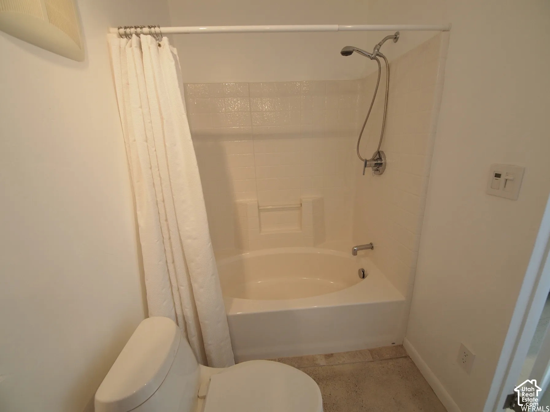 Full-size soaking tub with integrated tile-surround and handheld shower head