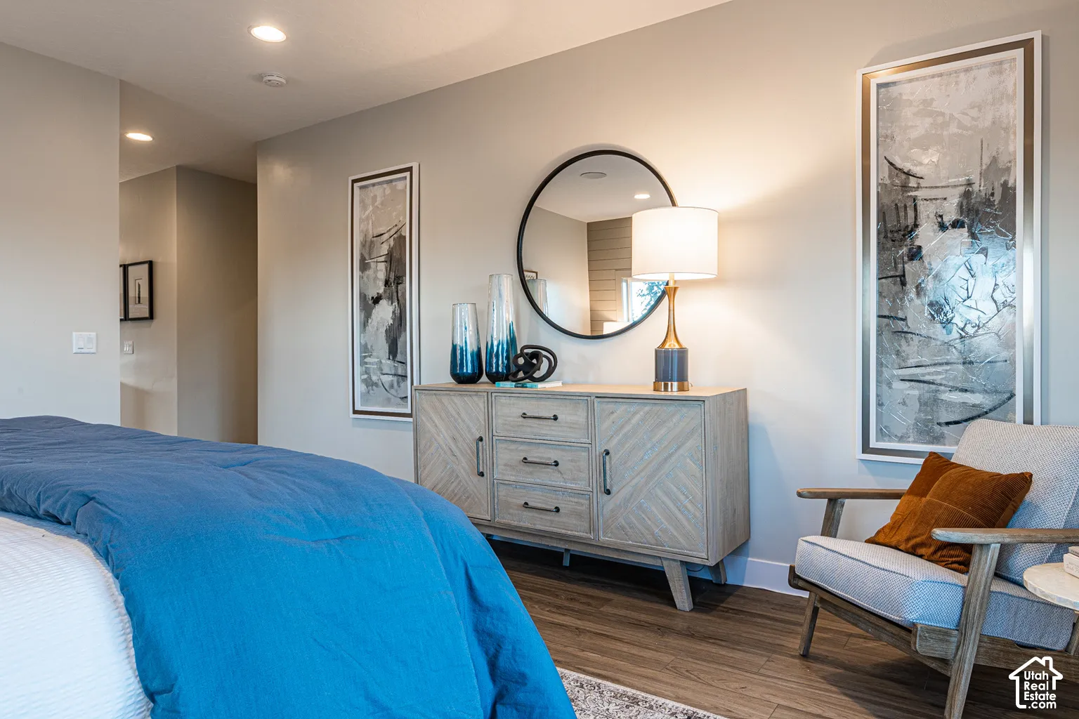 Neutral wall tones, recessed lighting, and wood-finish flooring
