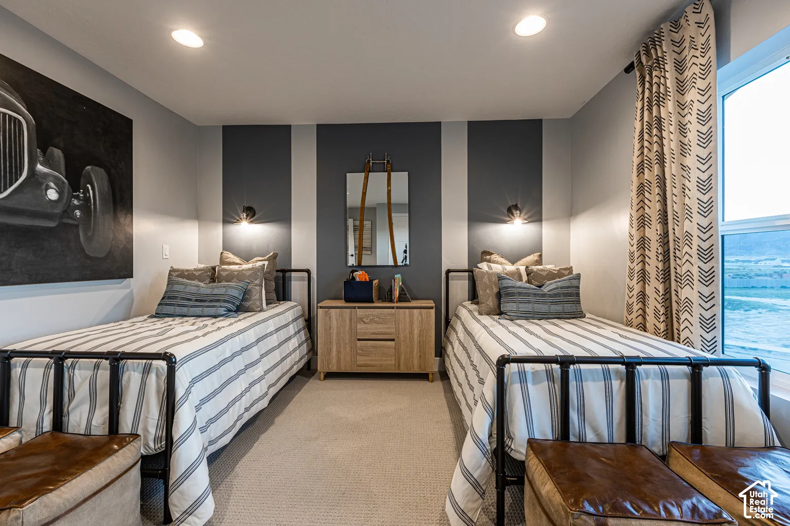 Room featuring neutral carpeting, dual wall-mounted light fixtures, and a dual-tone accent wall