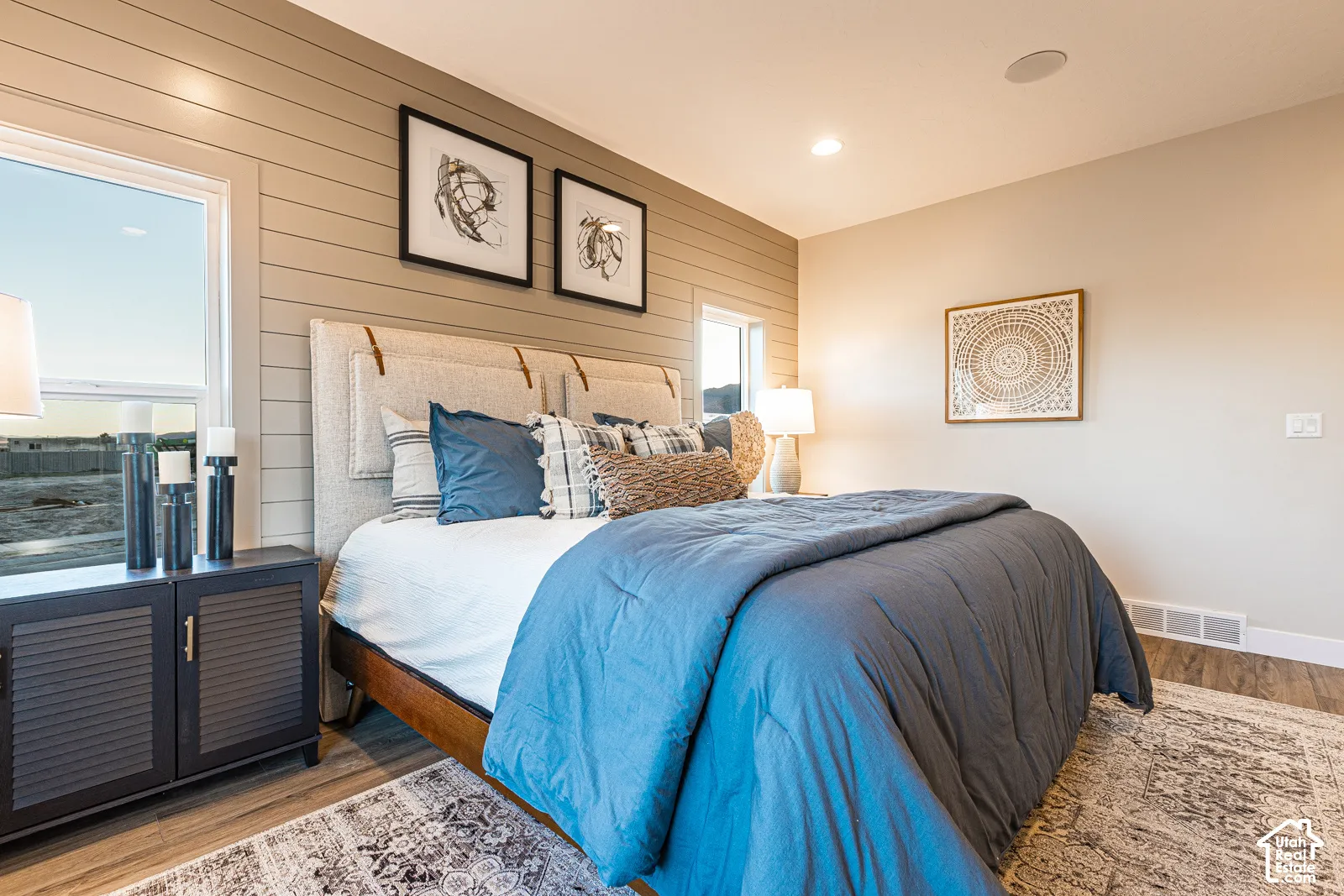 Horizontal shiplap accent wall, wood-finish flooring, and recessed ceiling lighting