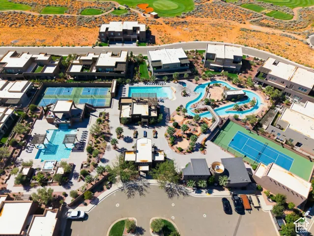 Community grounds featuring multiple swimming pools, a lazy river, tennis courts, and landscaped hardscaping