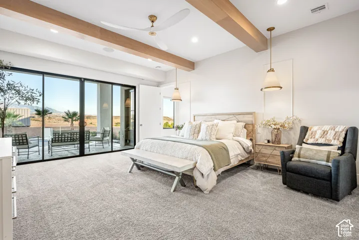 Exposed timber ceiling beams, floor-to-ceiling sliding glass doors, recessed lighting, and dual pendant light fixtures