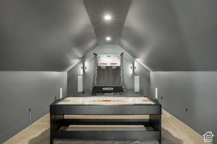 Vaulted ceiling featuring neutral-tone walls, recessed lighting, and wall-mounted sconces with wall-to-wall carpeting
