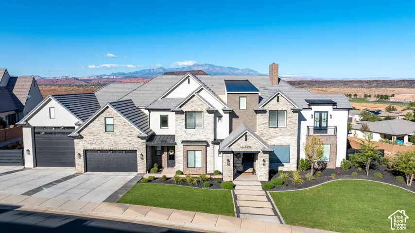 Multi-level exterior featuring a stone and stucco fa