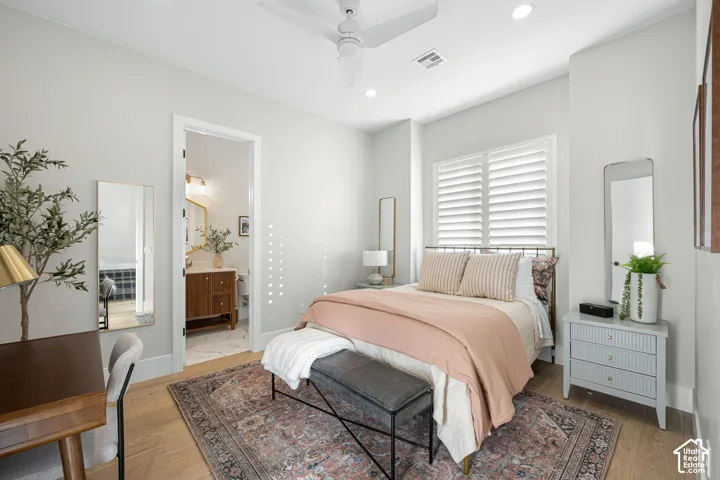 Bedroom featuring wood-finish flooring, recessed lighting, a ceiling fan, and window shutters