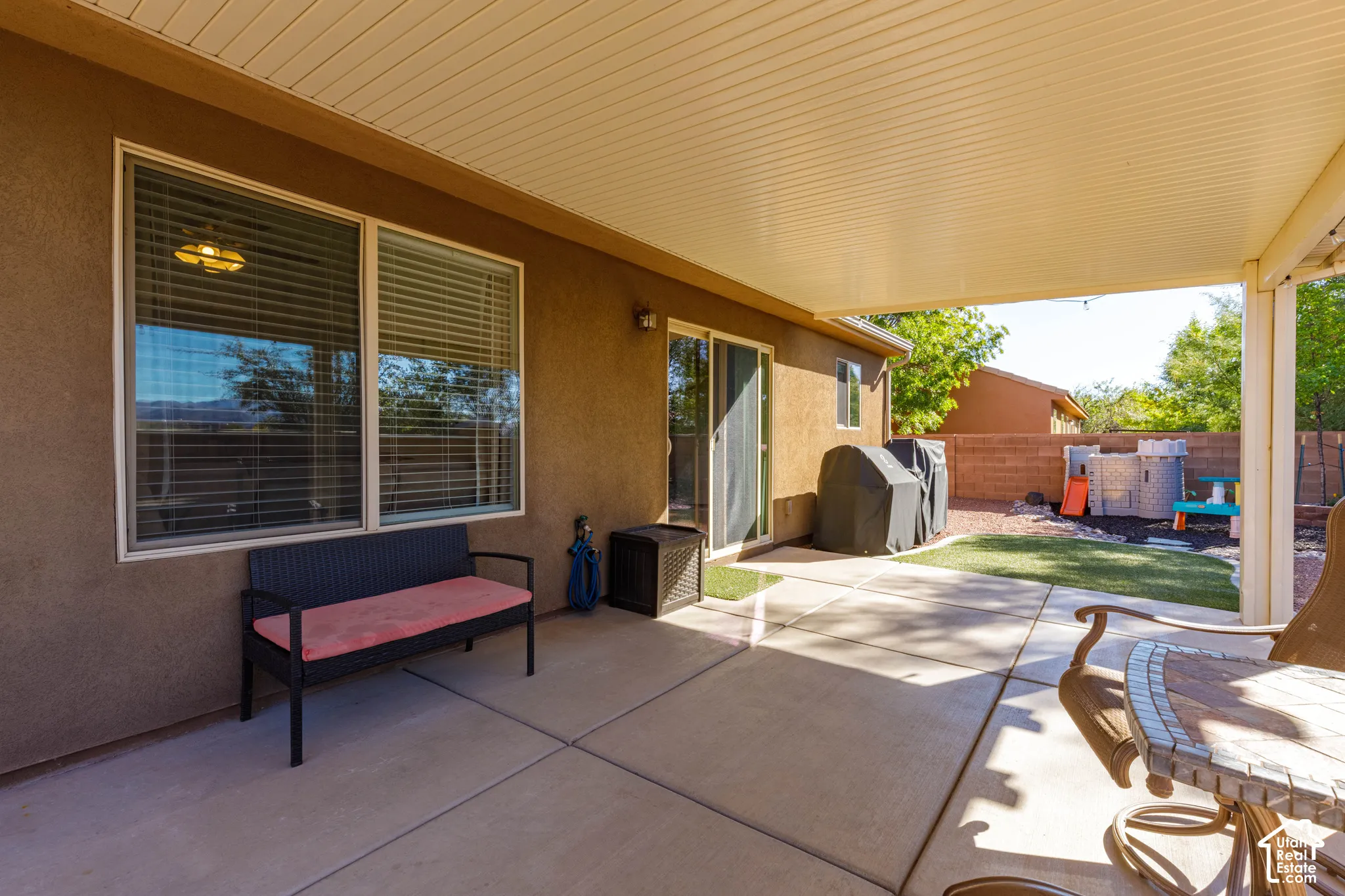 Covered concrete patio featuring recessed ceiling lighting, a stucco exterior, and sliding glass door access
