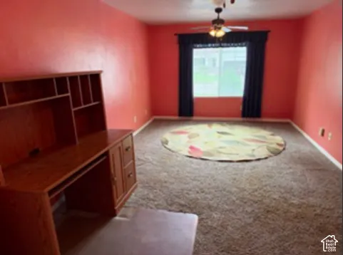 wall-to-wall carpeting, single-pane window with natural light exposure, and ceiling-mounted light fixture with a central fan