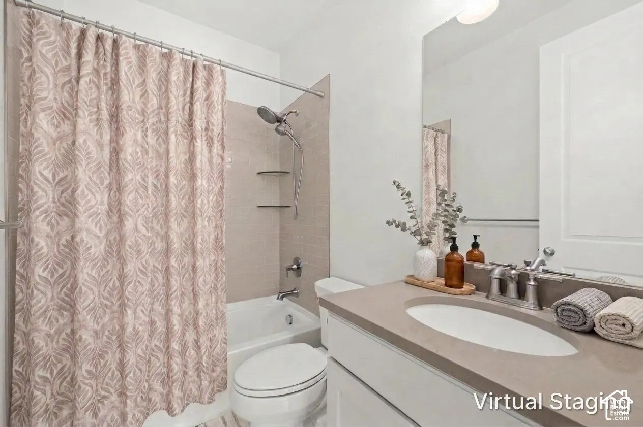 Bathroom featuring a vanity with a solid-surface countertop, an integrated oval sink, a wall-mounted mirror, a tub-shower combination with tile surround, and built-in glass shelving