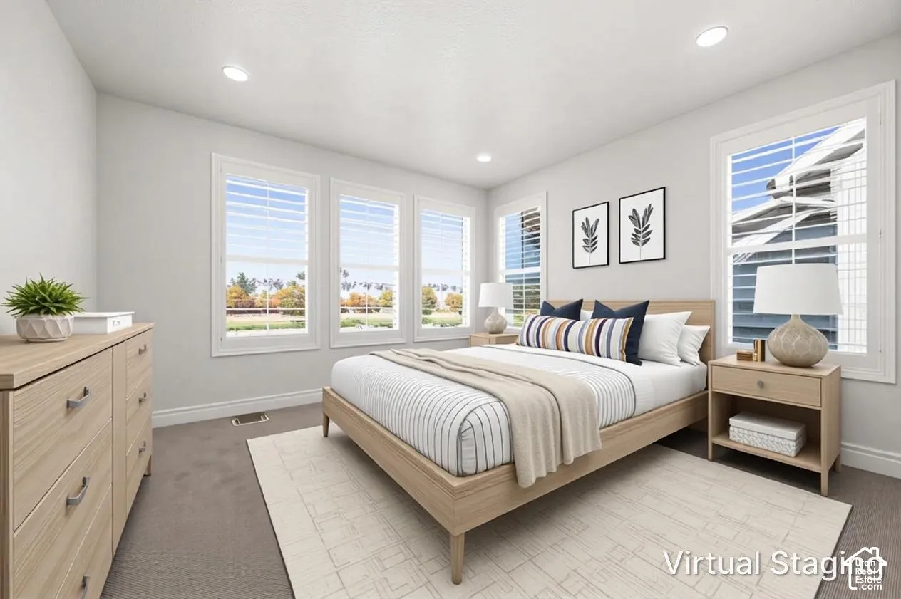 Neutral interior featuring recessed lighting, carpeting, and multiple windows equipped with plantation shutters