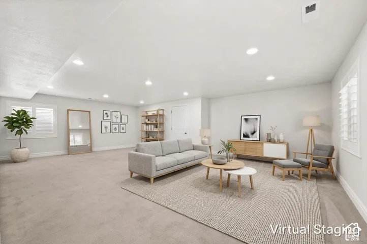 Neutral-toned wall-to-wall carpeting, recessed ceiling lighting, and plantation shutter window treatments