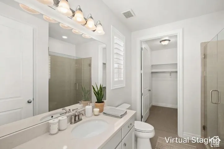 Bathroom featuring a vanity with a light-toned countertop, integrated basin, and multi-bulb vanity lighting