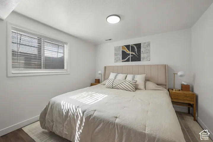 Neutral interior featuring white walls, wood-finish flooring, and a recessed window
