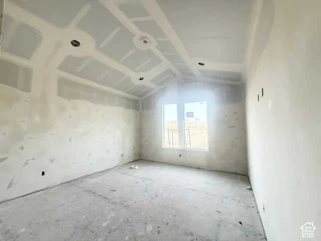 Vaulted ceiling with recessed lighting and large single-pane window