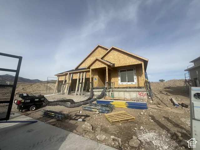 New construction featuring a multi-gabled roofline, covered entryway, and attached multi-car garage