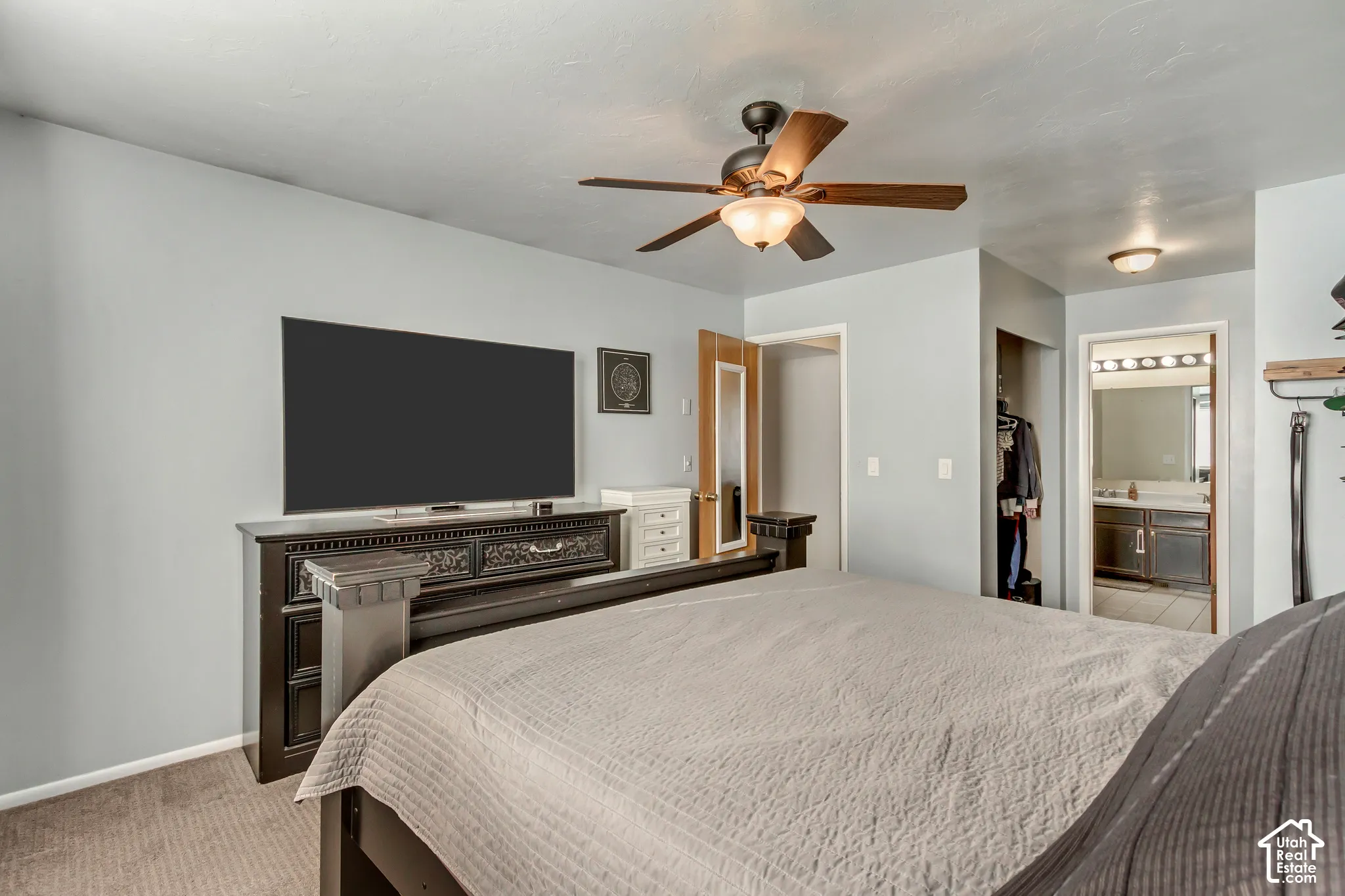Room featuring a ceiling fan with integrated lighting, neutral wall paint, and wall-to-wall carpeting