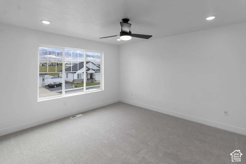 Neutral interior featuring wall-to-wall carpeting, recessed lighting, and a modern matte black ceiling fan with an integrated light fixture