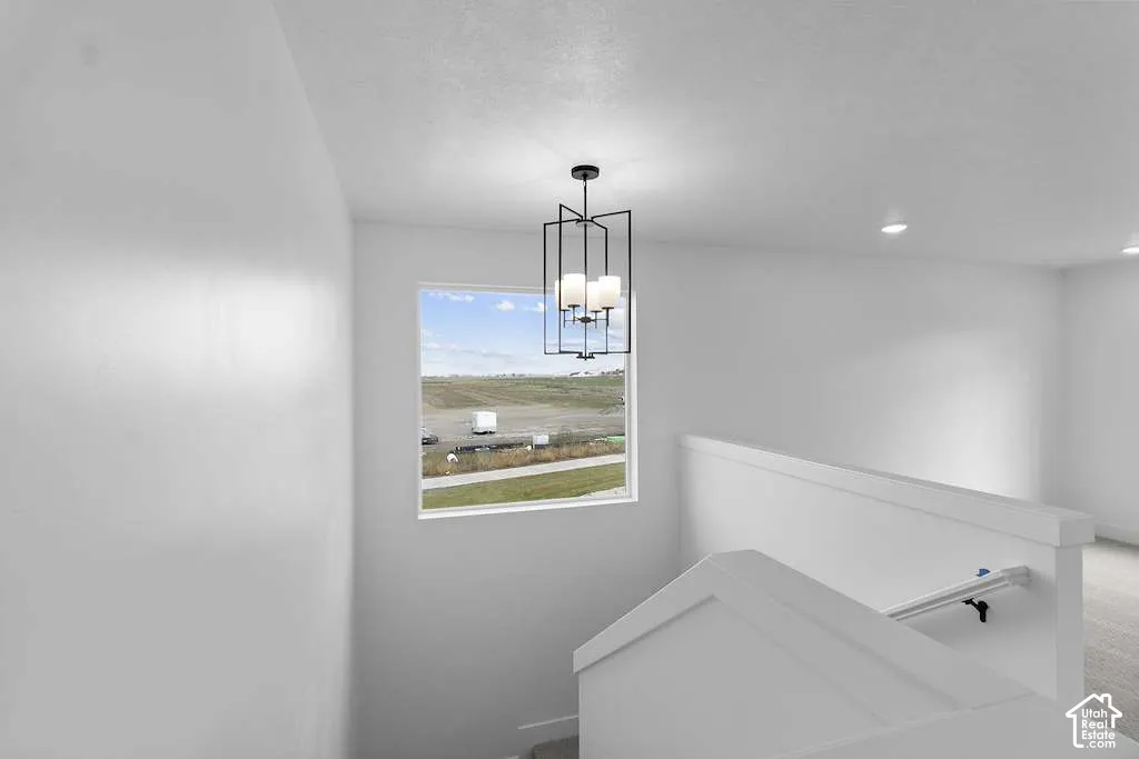 Matte black geometric lantern pendant light, large square window, and neutral wall finish