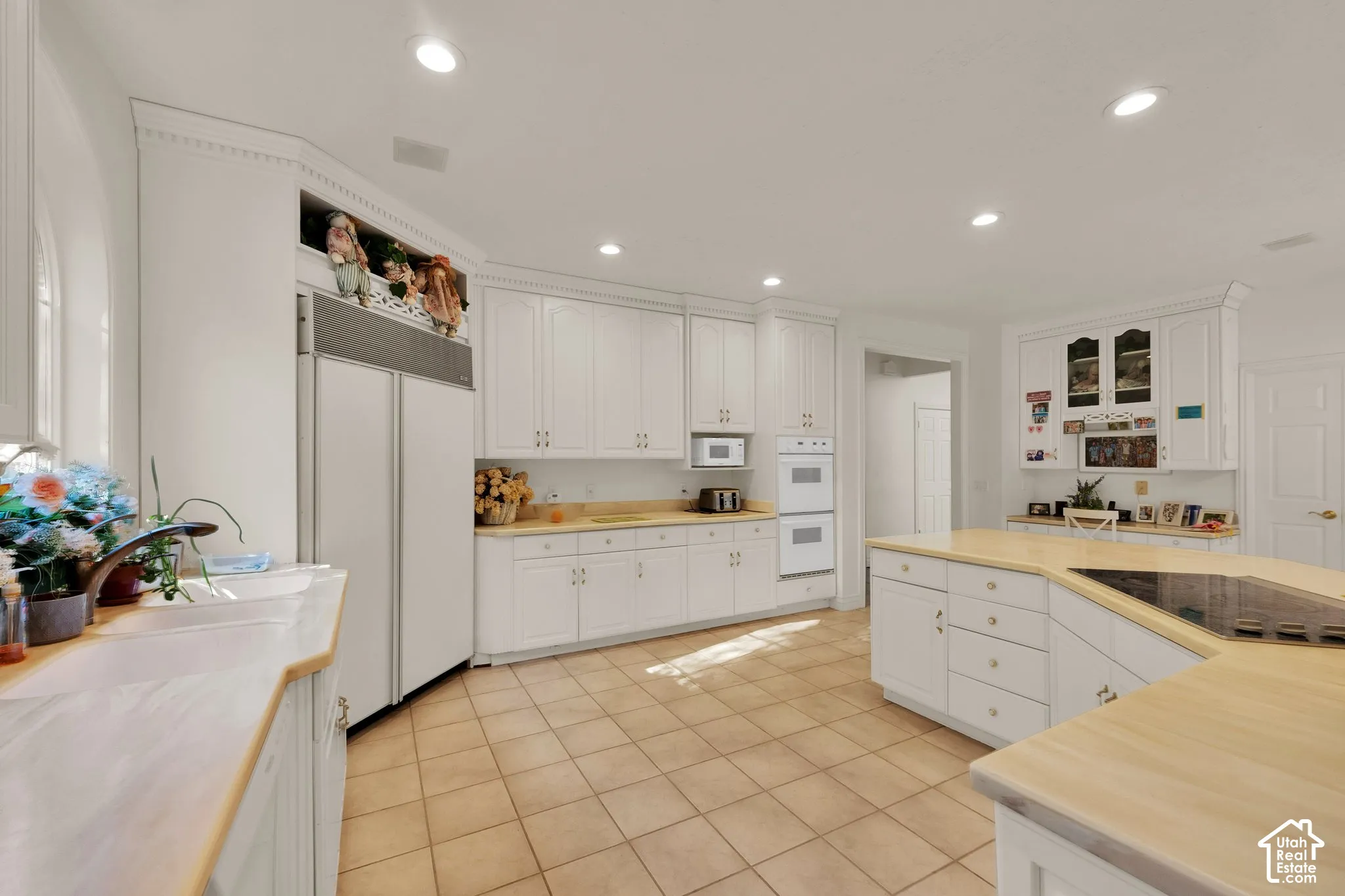 Kitchen featuring white cabinetry, light-toned countertops, recessed lighting, tile flooring, and integrated wall oven