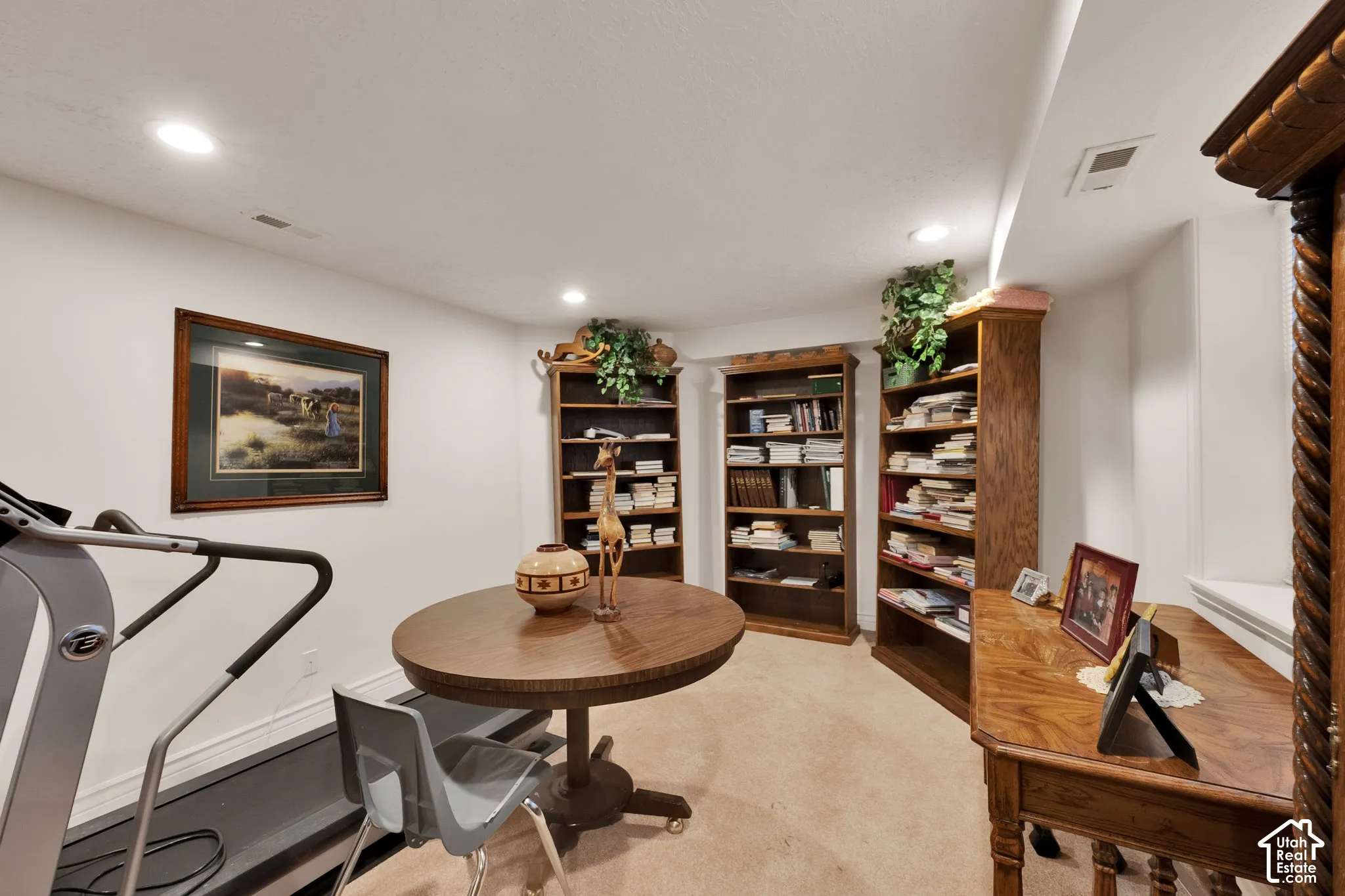 Interior room featuring recessed ceiling lighting, wall-to-wall carpeting, and three built-in wooden shelving units