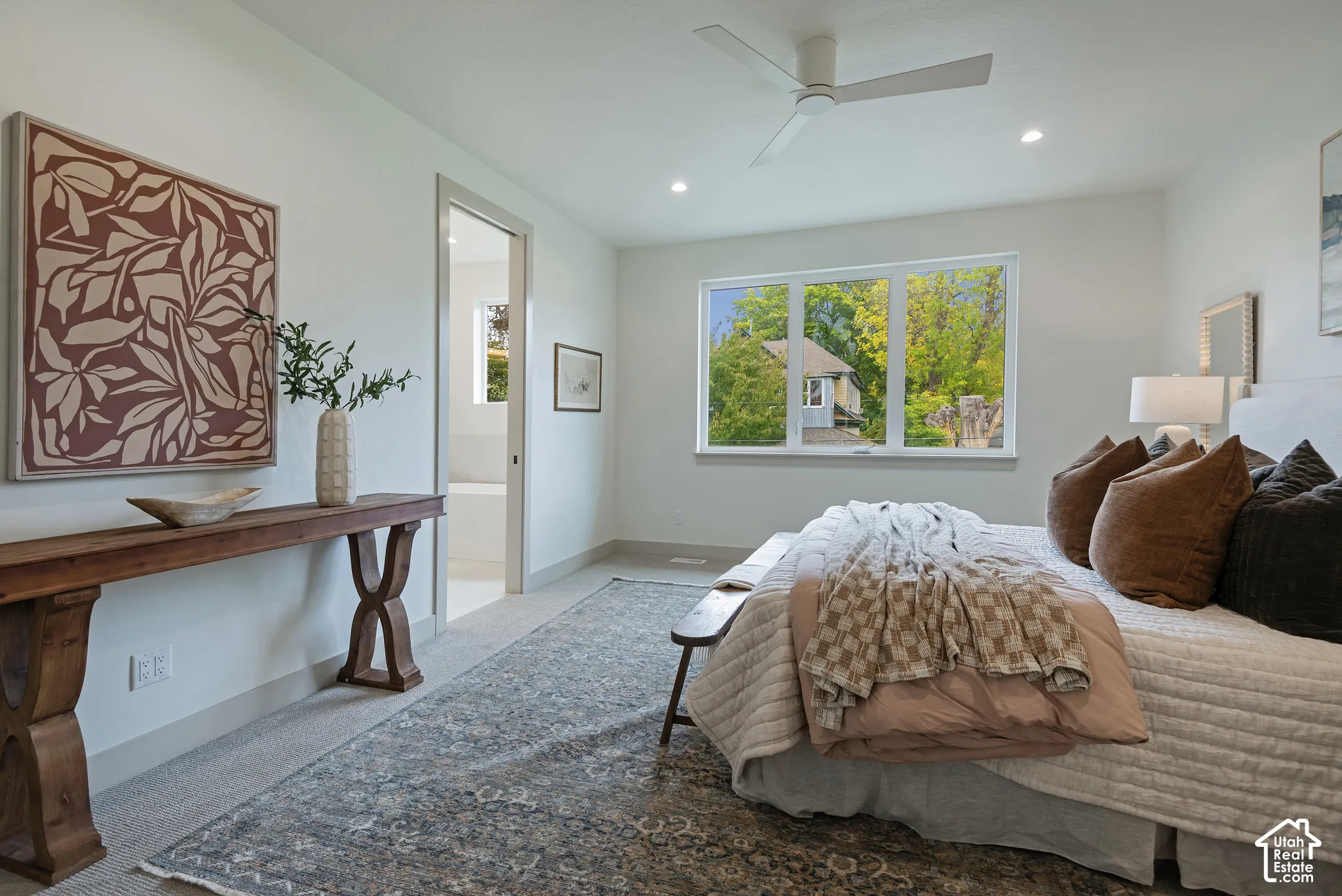 Neutral-toned bedroom featuring recessed lighting, a multi-blade ceiling fan, and large-pane windows