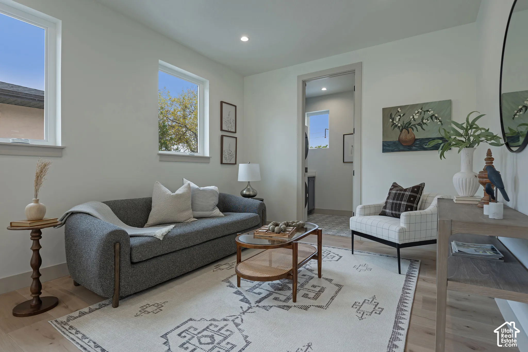 Room featuring light-toned wood-finish flooring, recessed lighting, and double-pane windows
