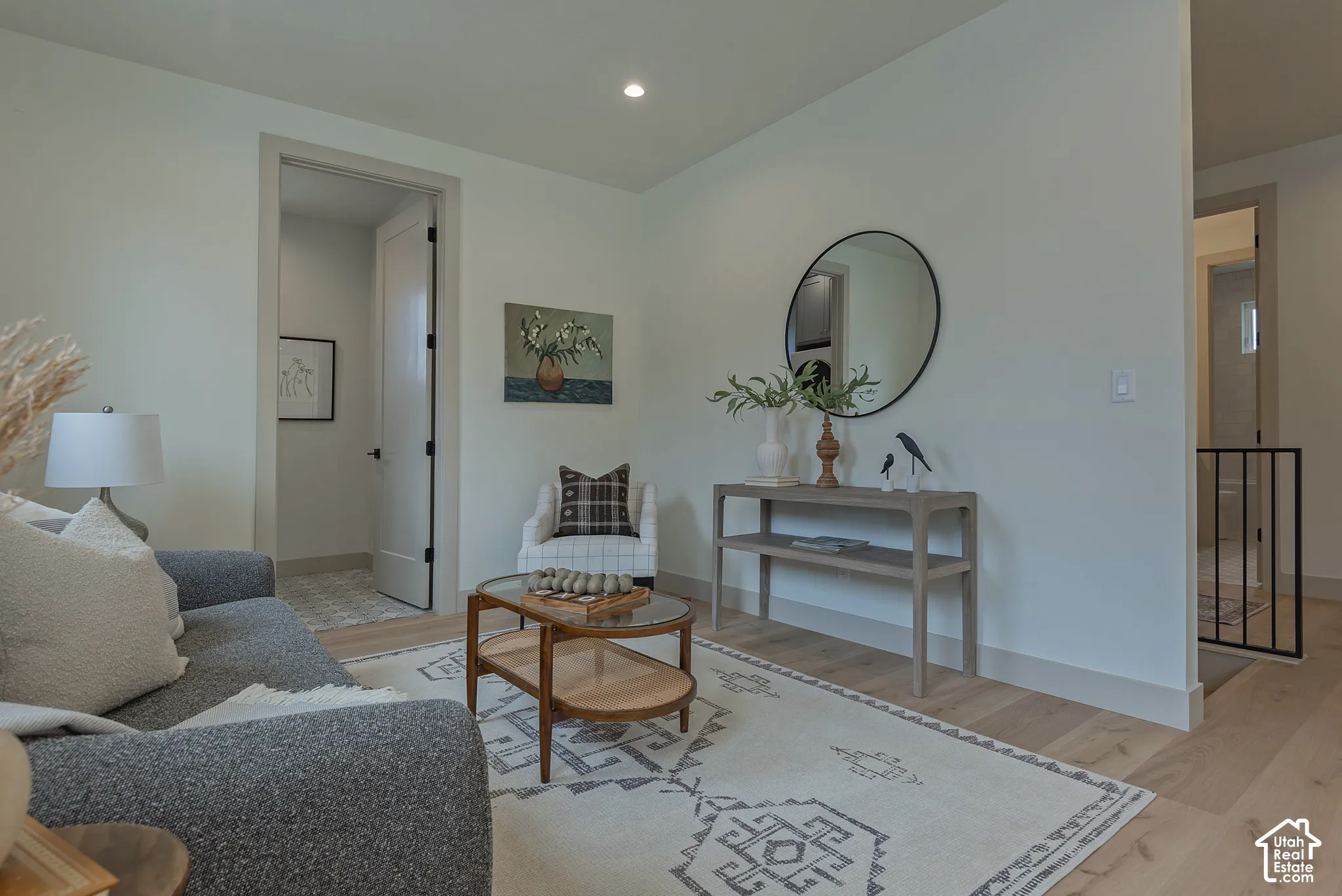 Wood-finish flooring, recessed lighting, and solid-core doors with matte black hardware