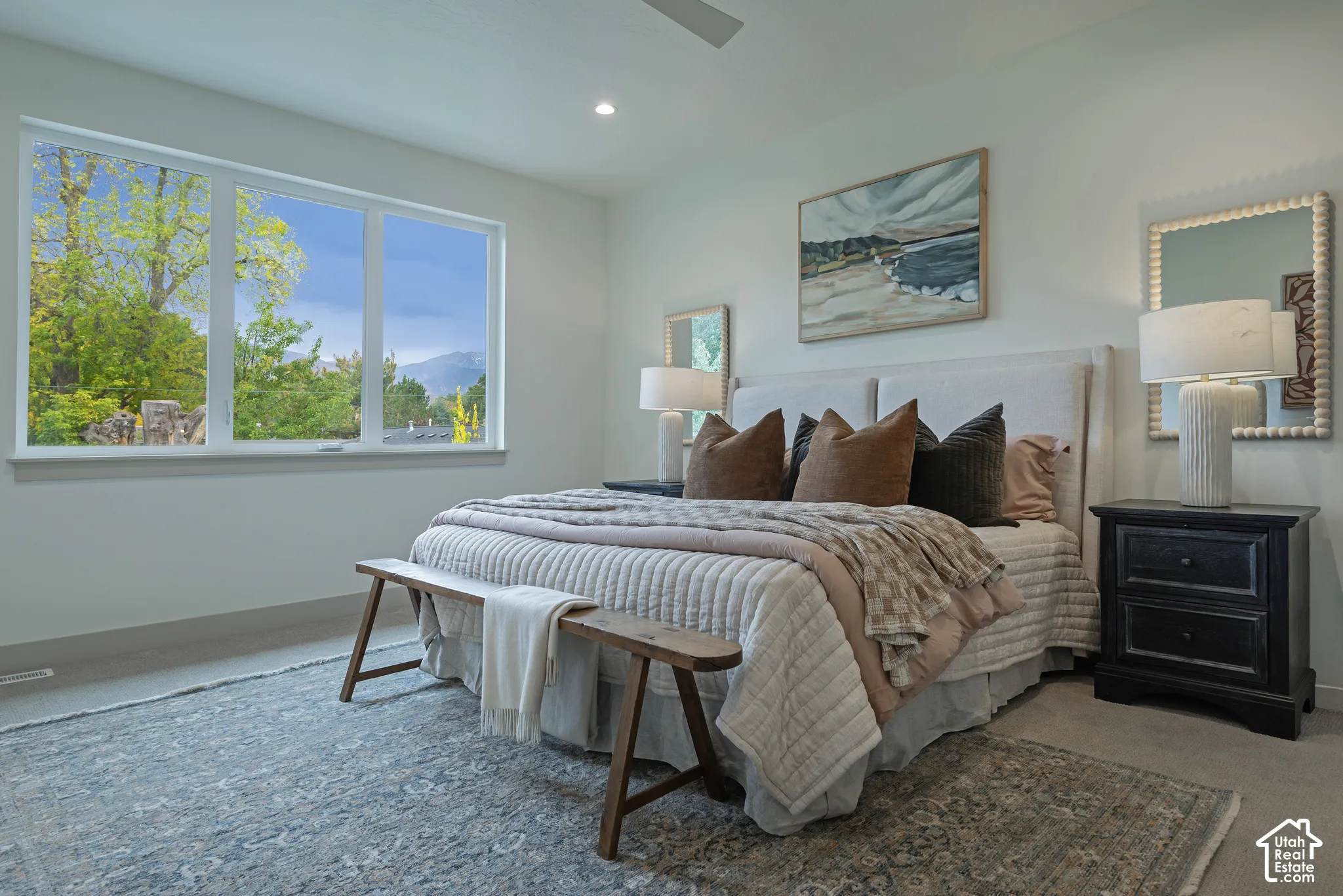 Large window featuring mountain scenery, neutral wall tones, and recessed lighting