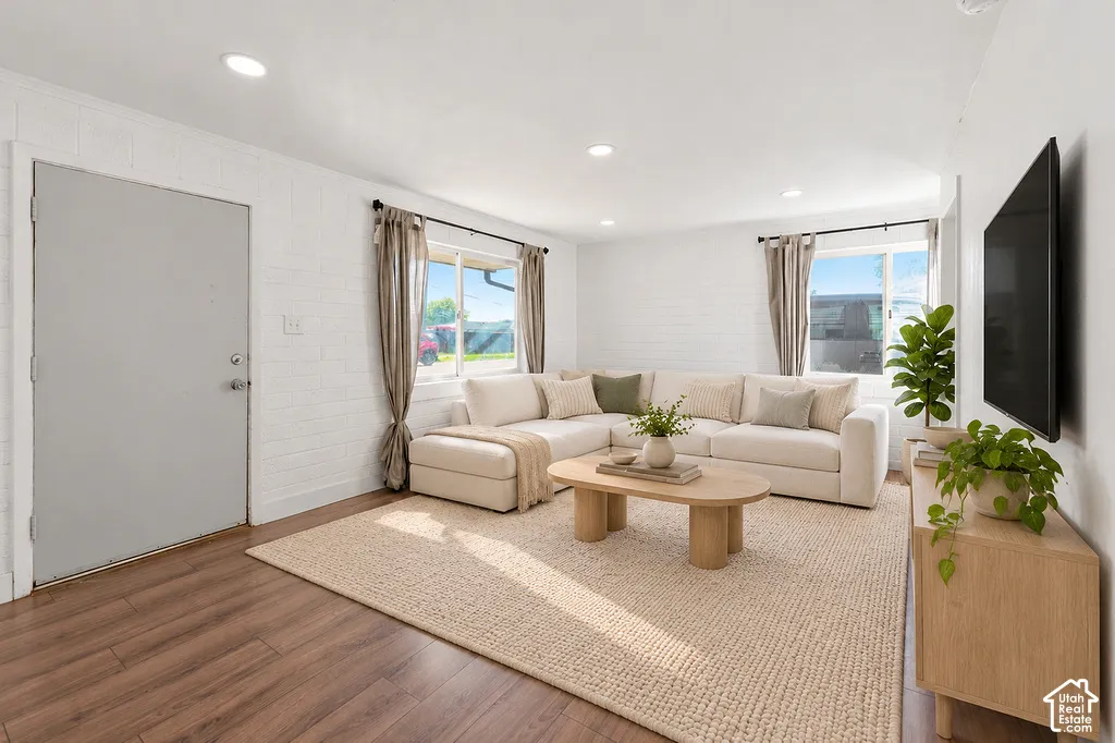 Interior featuring white painted masonry walls, wood-finish flooring, and recessed ceiling lighting