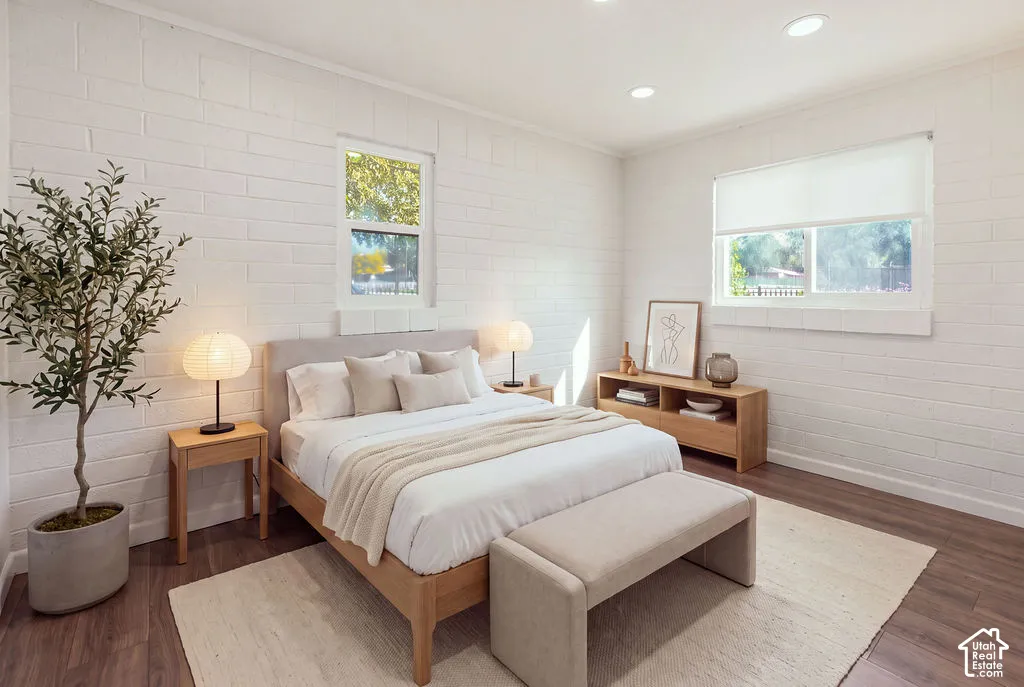 Textured painted masonry walls, wood-finish flooring, and recessed ceiling lighting
