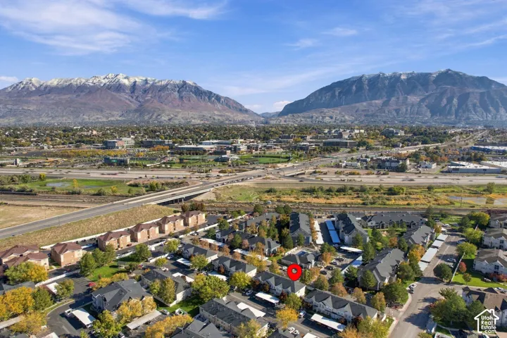 Aerial perspective showcasing multi-unit residential buildings with shingled roofing and mountain backdrop