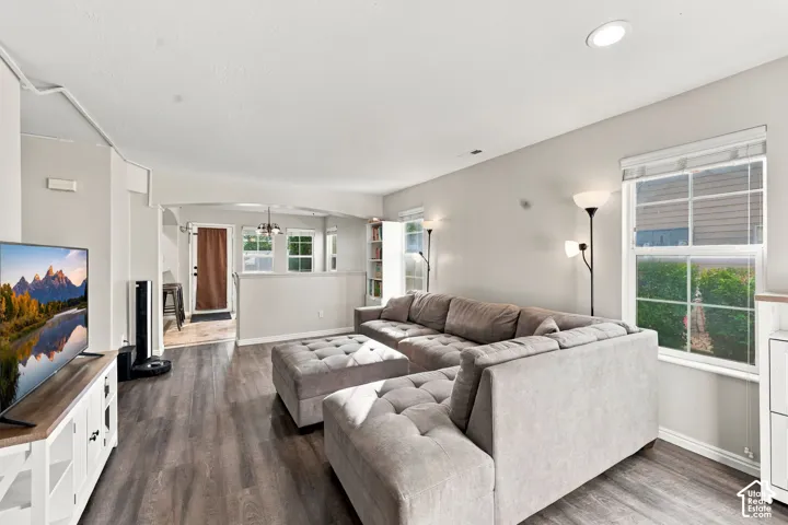 Wood-finish flooring, recessed lighting, grid-pattern windows, and a semi-partitioned arched entryway