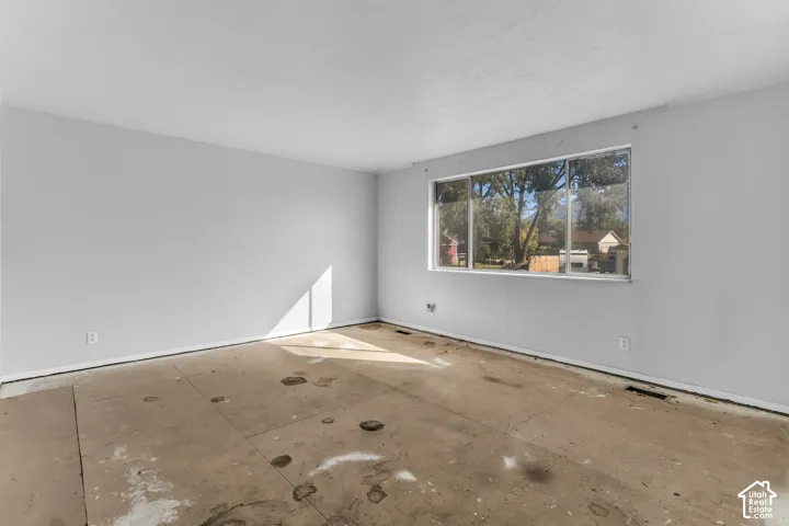 Interior room featuring neutral wall paint and a large horizontal window providing natural light