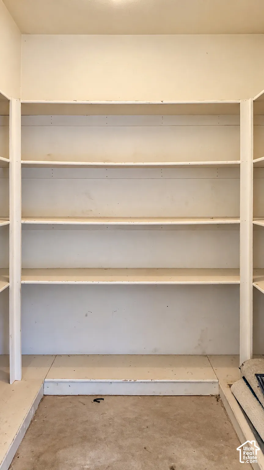 Built-in storage area featuring multiple tiers of painted shelving