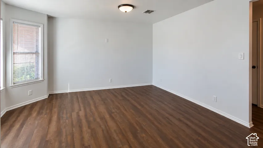 Interior space featuring wood-finish flooring, a bay window, and a flush-mount ceiling light fixture