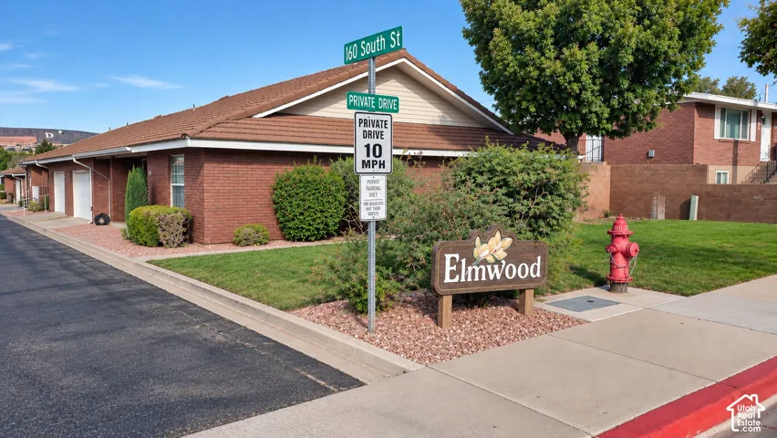 Brick exterior, tile roof, and private drive access