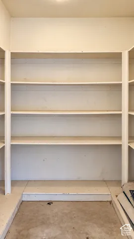 Built-in storage area featuring multiple tiers of painted shelving