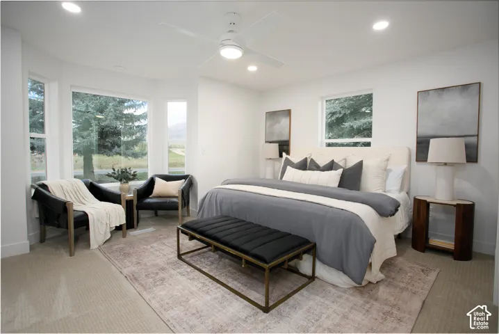 Bay window featuring multi-pane glass, neutral wall tones, recessed lighting, and a centralized ceiling fan