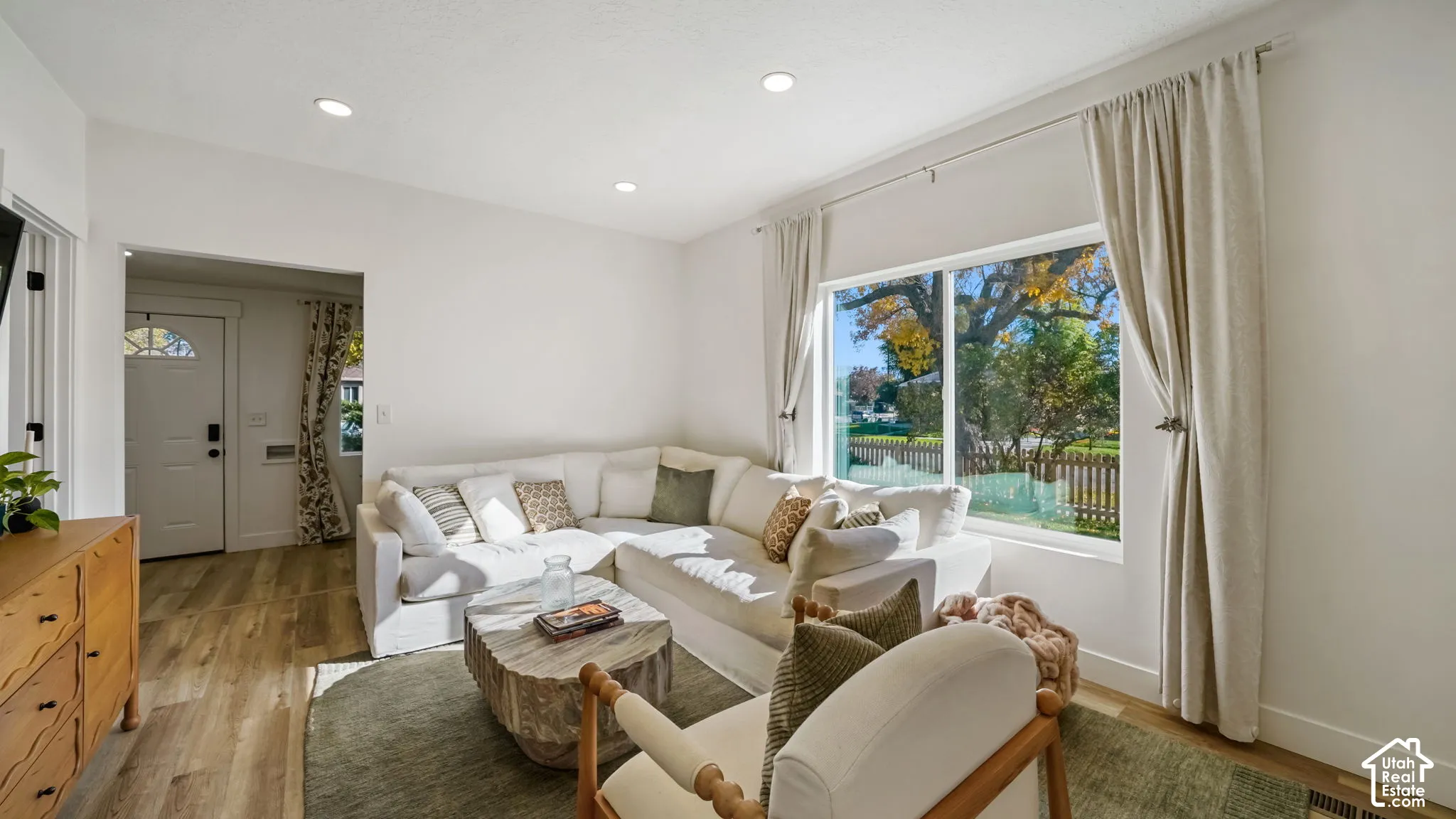 Living area featuring recessed lighting, wood-finish flooring, and a large picture window