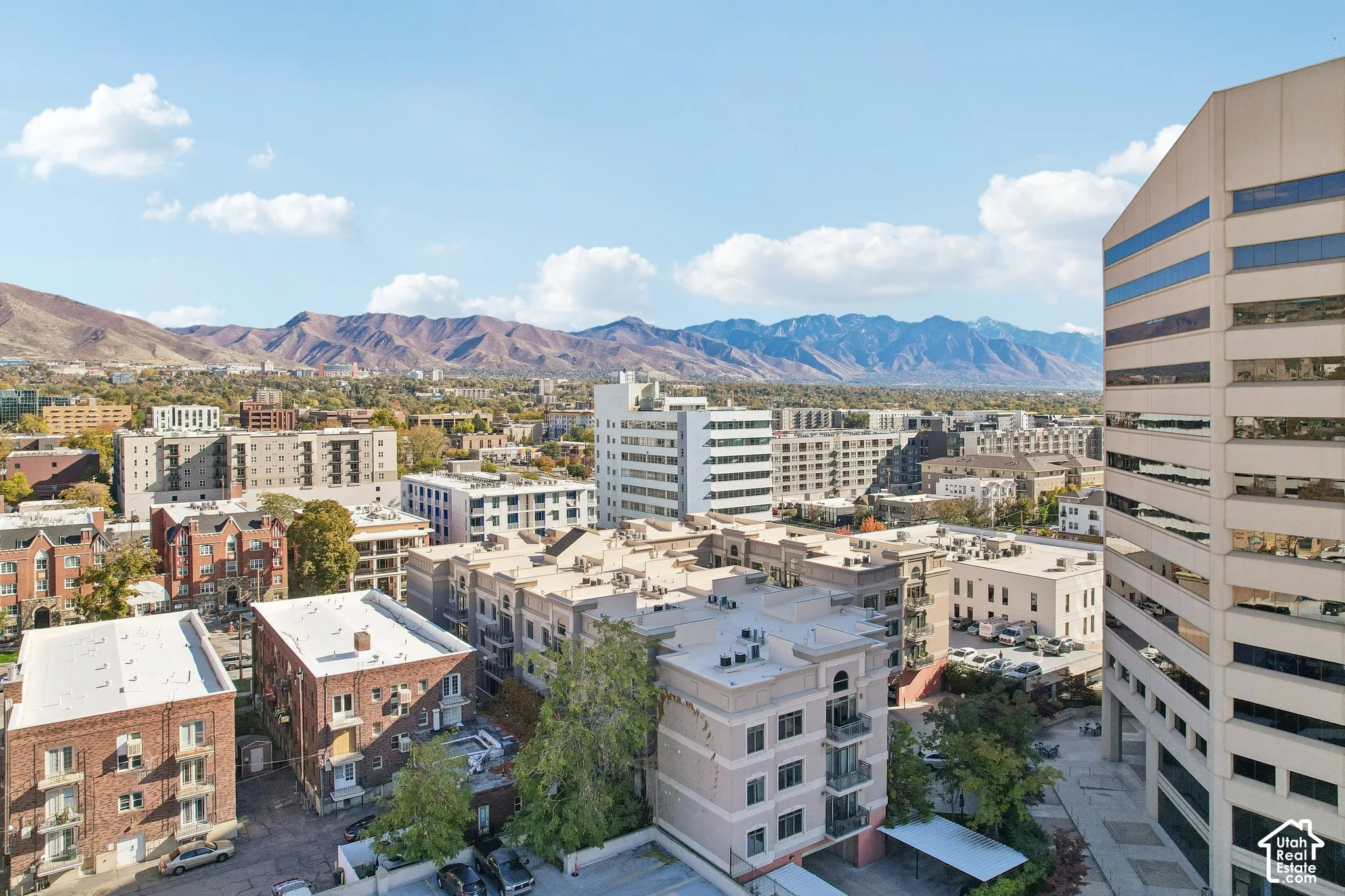 Urban setting featuring mid-rise and high-rise structures with prominent mountain backdrop