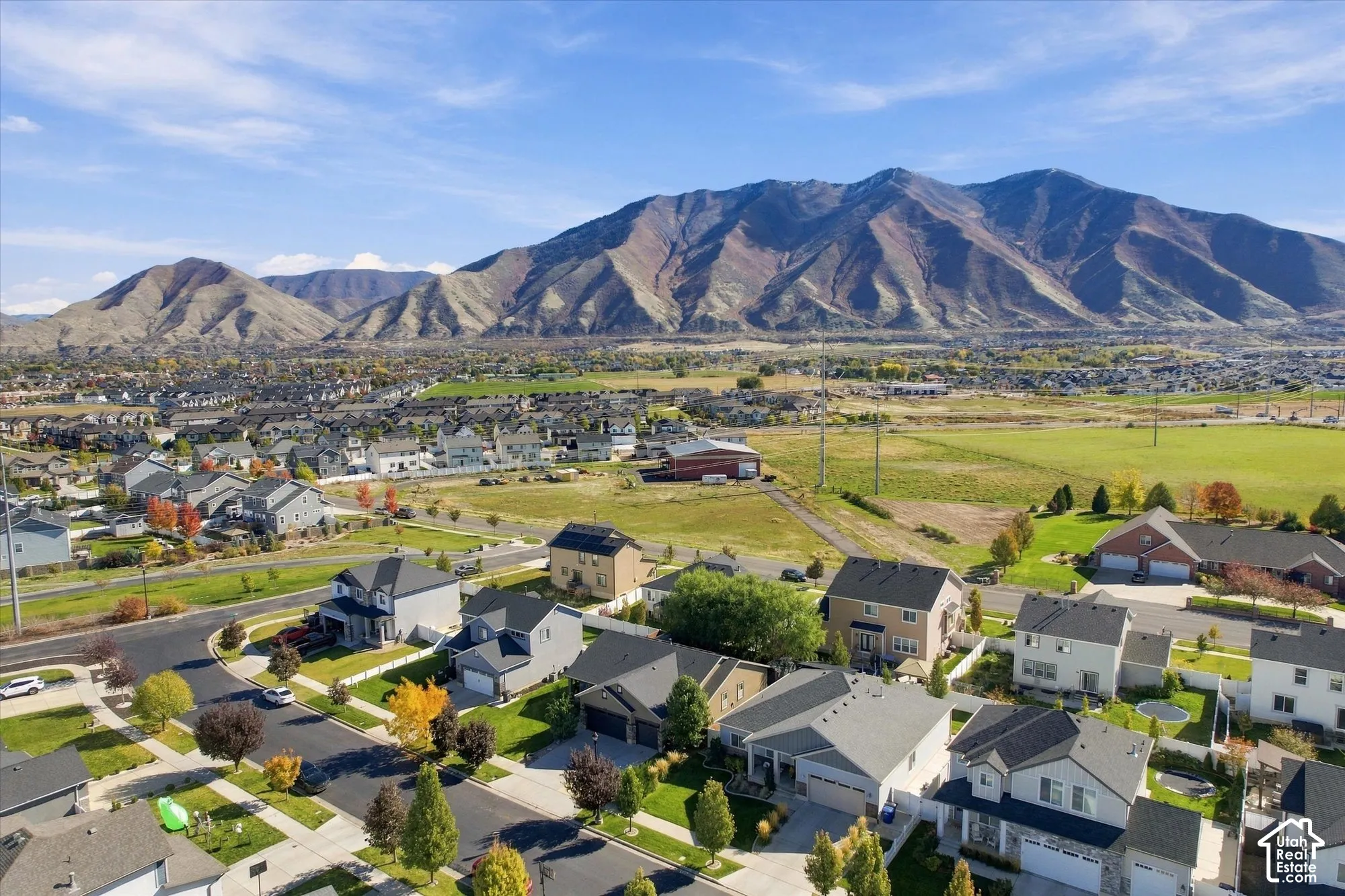 Aerial perspective showcasing a residential community with prominent mountain range backdrop