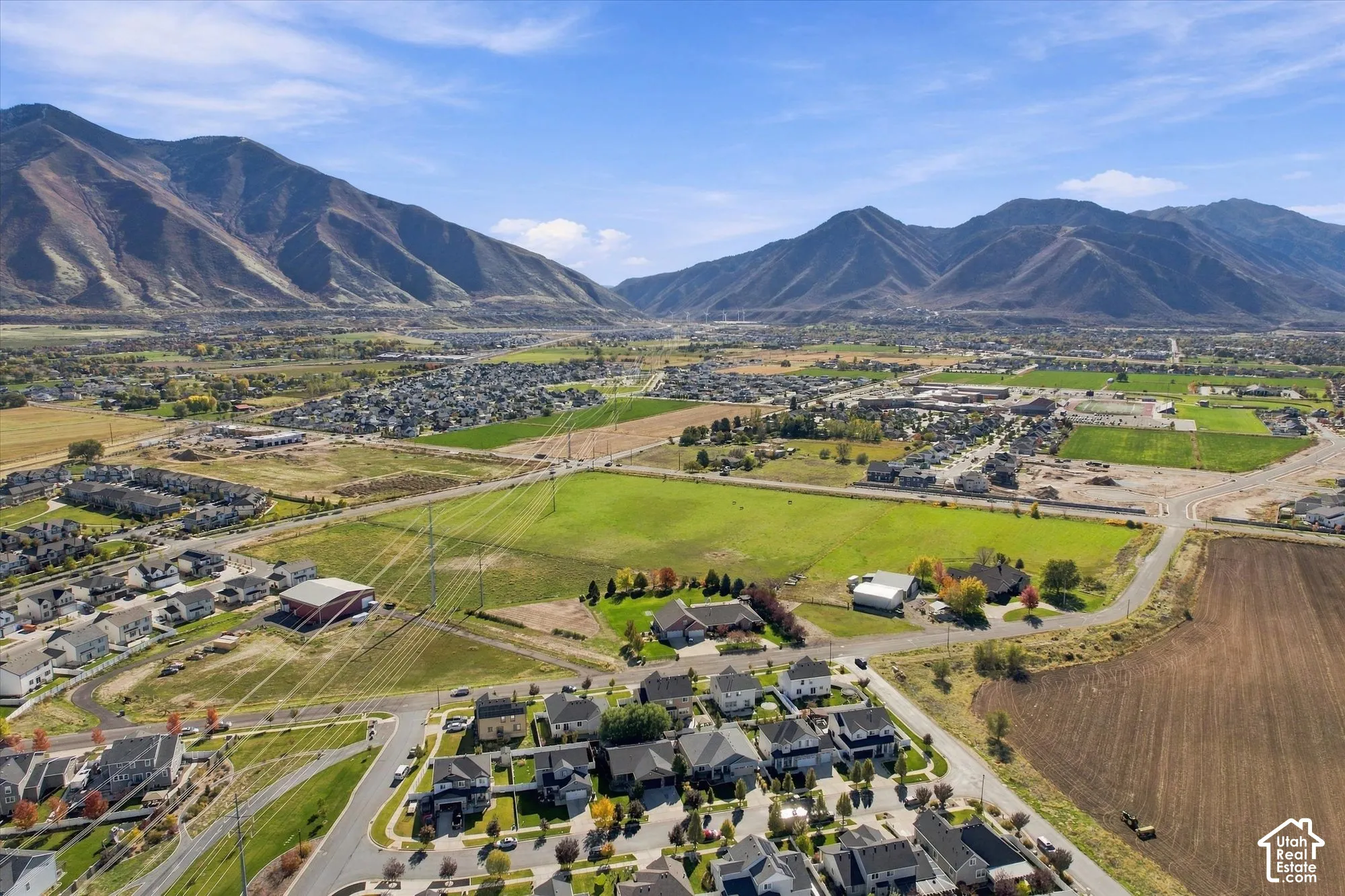 Aerial perspective featuring expansive mountain range backdrop and rural acreage