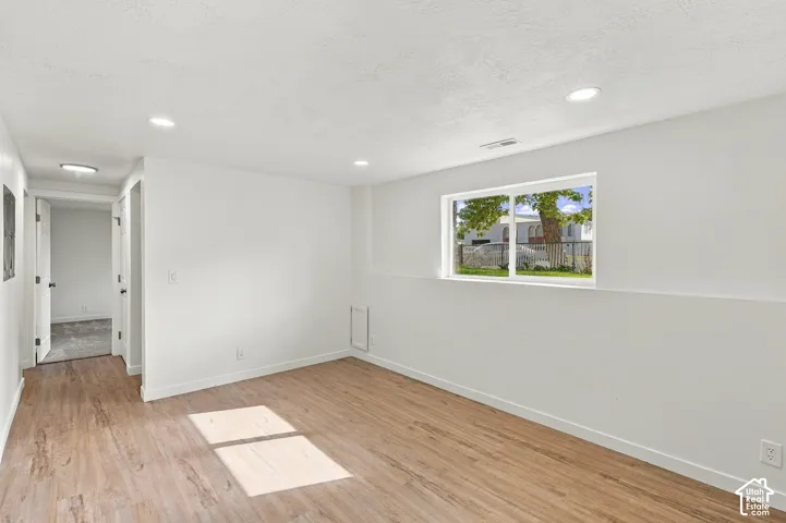 Interior space featuring wood-finish flooring, recessed lighting, and a horizontal sliding window