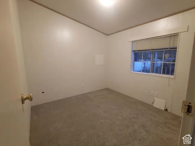 2nd Bedroom Neutral-toned carpeting, vaulted ceiling, and dual-pane window with interior blinds